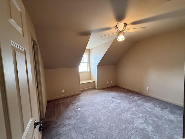 bonus room featuring light carpet, vaulted ceiling, a ceiling fan, and baseboards