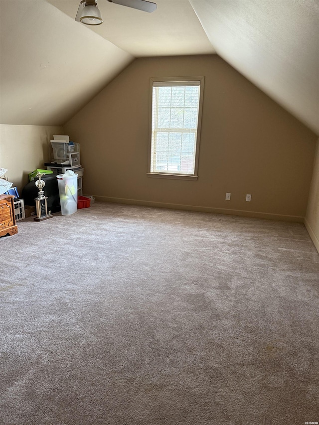 bonus room with lofted ceiling, baseboards, and carpet flooring