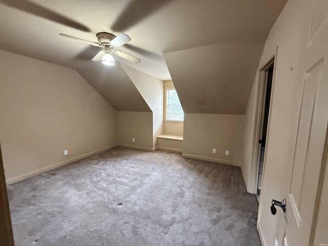 bonus room featuring light carpet, baseboards, vaulted ceiling, and a ceiling fan