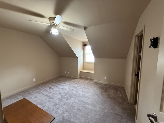 additional living space featuring lofted ceiling, light carpet, ceiling fan, and baseboards