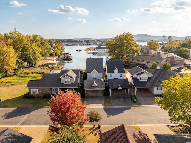 drone / aerial view featuring a water view and a residential view