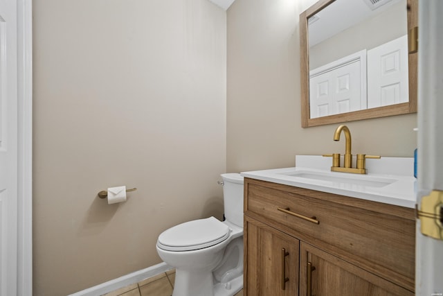 bathroom with visible vents, toilet, vanity, baseboards, and tile patterned floors