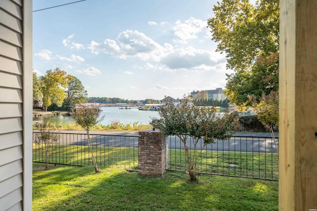 view of yard with a water view and fence