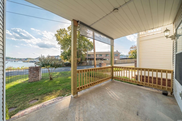 view of patio featuring a water view and a fenced backyard