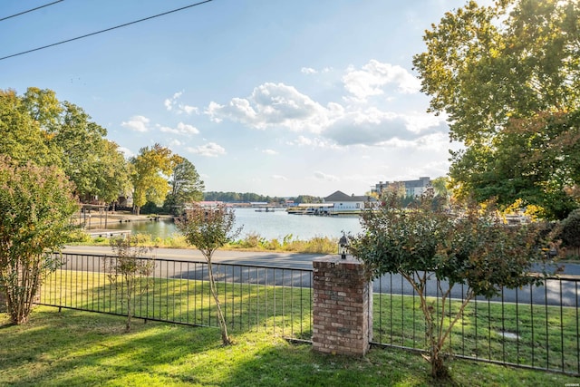 view of yard with a water view and fence