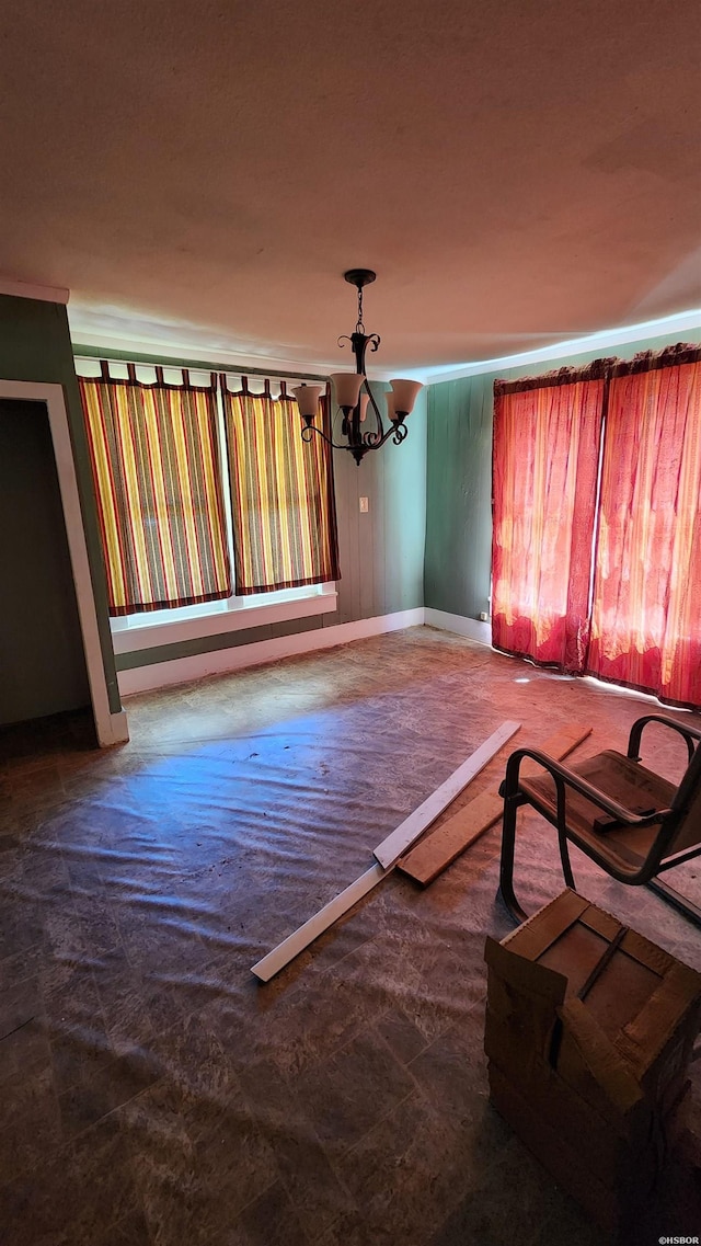 357 W Walnut St, Prescott, AR 71857 - unfurnished living room with a chandelier and baseboards