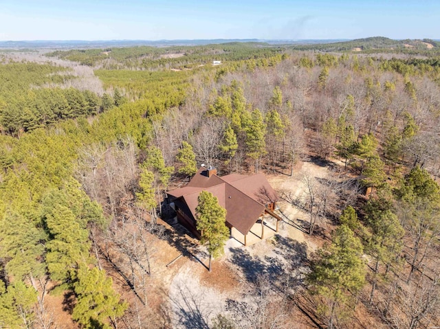 drone / aerial view featuring a wooded view