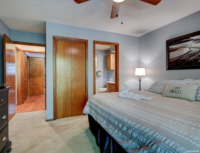 8 Redbird Ln Unit D, Mount Ida, AR 71957 - bedroom with light colored carpet, ensuite bathroom, a closet, a textured ceiling, and ceiling fan
