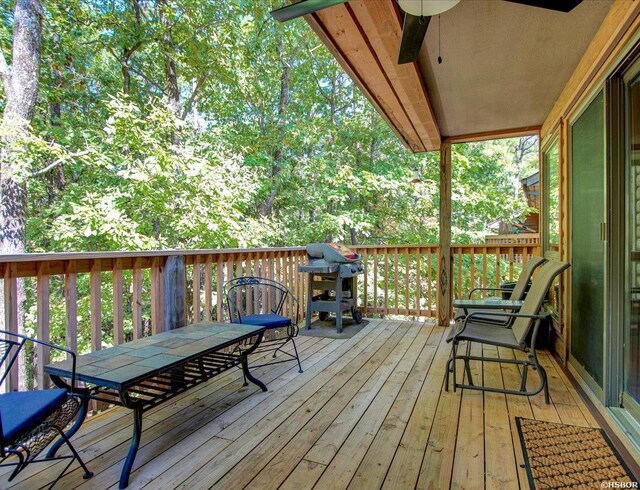 8 Redbird Ln Unit D, Mount Ida, AR 71957 - wooden deck with outdoor dining area and a grill