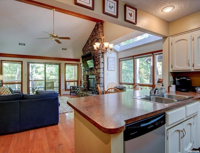 8 Redbird Ln Unit D, Mount Ida, AR 71957 - kitchen featuring stainless steel dishwasher, open floor plan, a sink, white cabinets, and high vaulted ceiling