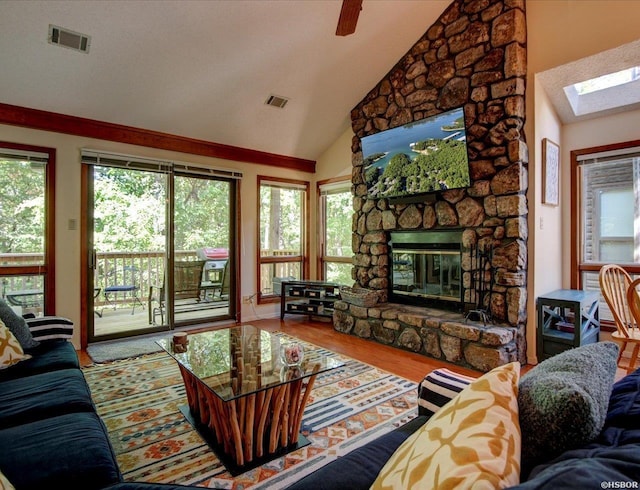 8 Redbird Ln Unit D, Mount Ida, AR 71957 - living area featuring a skylight, a fireplace, vaulted ceiling, and wood finished floors
