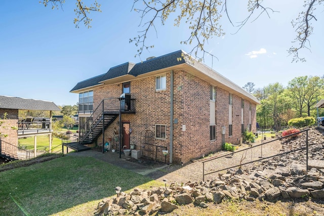 1135 Twin Points Rd Unit D, Hot Springs, AR 71913 - view of home's exterior featuring stairway, fence, a yard, mansard roof, and brick siding