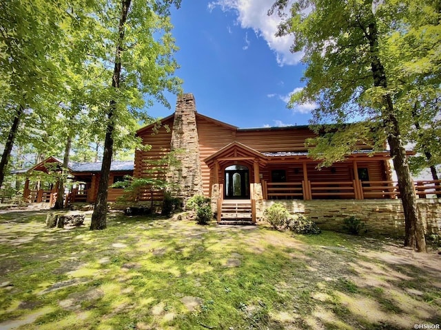 view of front of house featuring a chimney