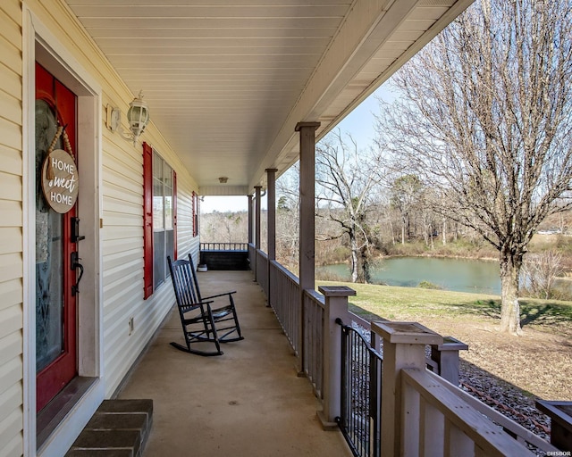 view of patio with a porch and a water view