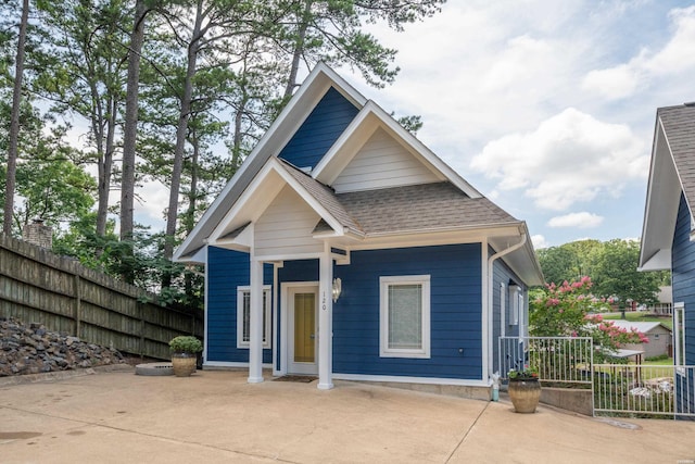 view of front of home with fence and roof with shingles