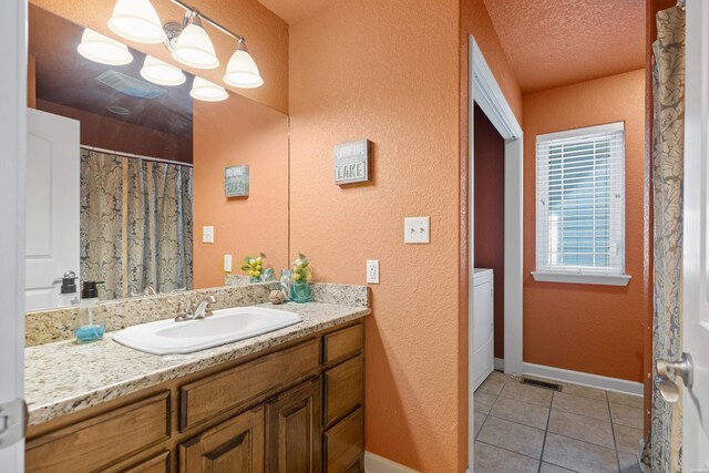 full bath with visible vents, a textured ceiling, vanity, tile patterned flooring, and baseboards