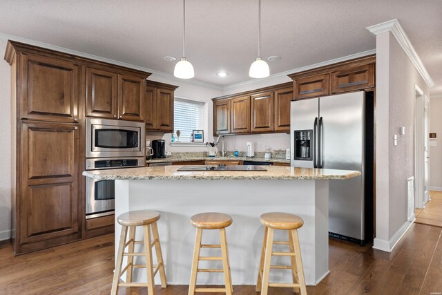 kitchen featuring light stone countertops, appliances with stainless steel finishes, and a center island