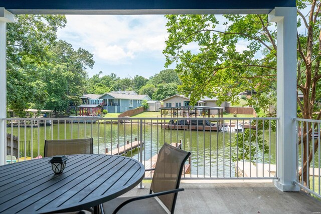 balcony featuring a water view and a boat dock