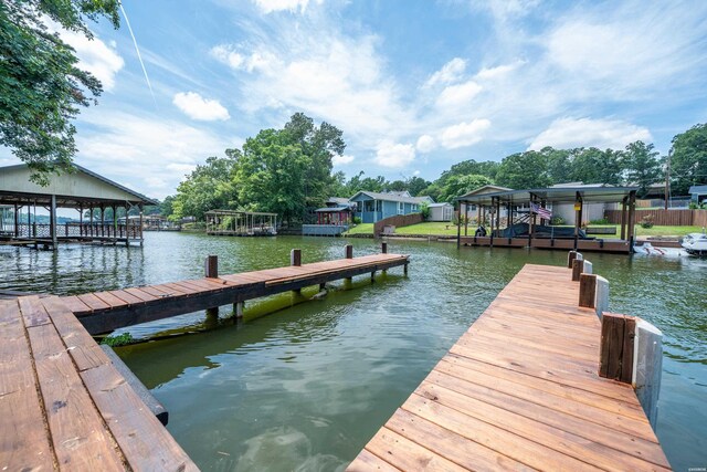 dock area with a water view and boat lift