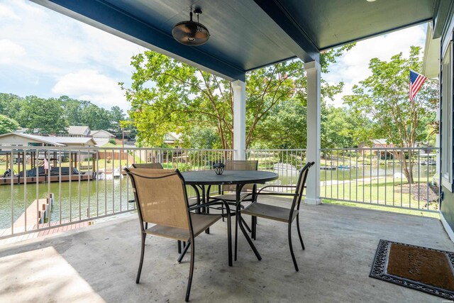 view of patio / terrace with a boat dock and a water view