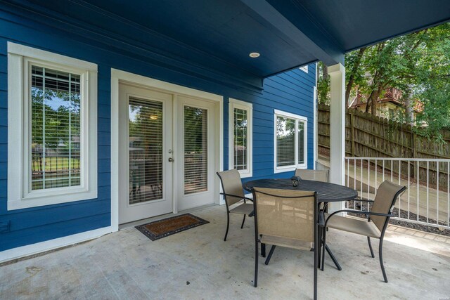 view of patio with fence and outdoor dining area