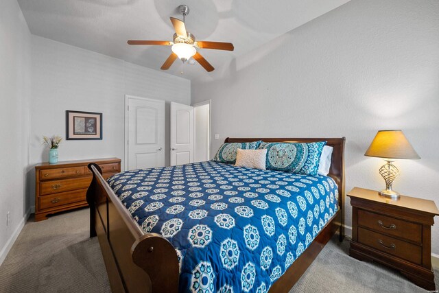 bedroom featuring light carpet, ceiling fan, and baseboards