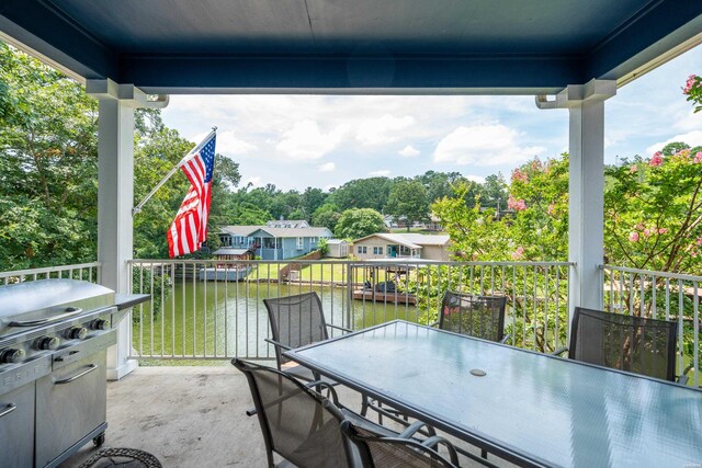 view of patio / terrace featuring outdoor dining area and a water view