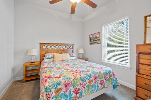 bedroom featuring baseboards, dark carpet, and ceiling fan