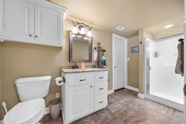 full bath with vanity, baseboards, visible vents, a shower stall, and toilet