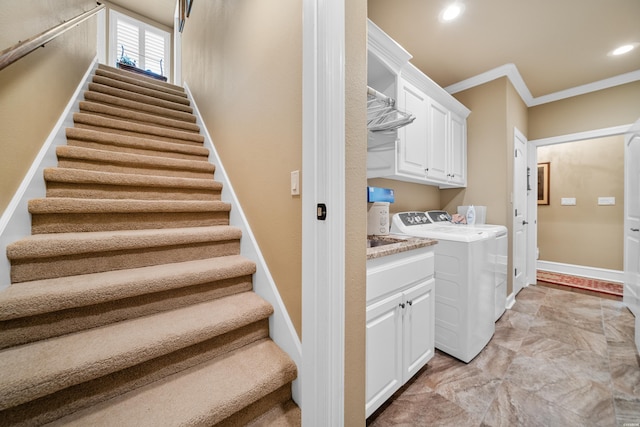 washroom featuring baseboards, cabinet space, recessed lighting, crown molding, and washing machine and dryer