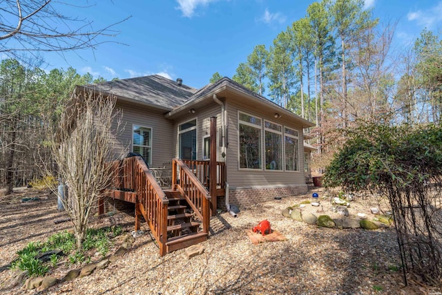 rear view of house with a deck and stairs