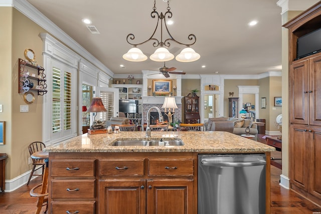 kitchen with a sink, stainless steel dishwasher, open floor plan, crown molding, and ceiling fan