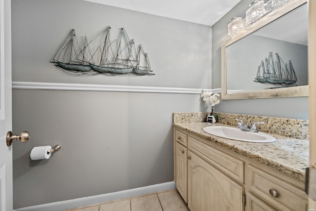 bathroom with baseboards, vanity, and tile patterned floors