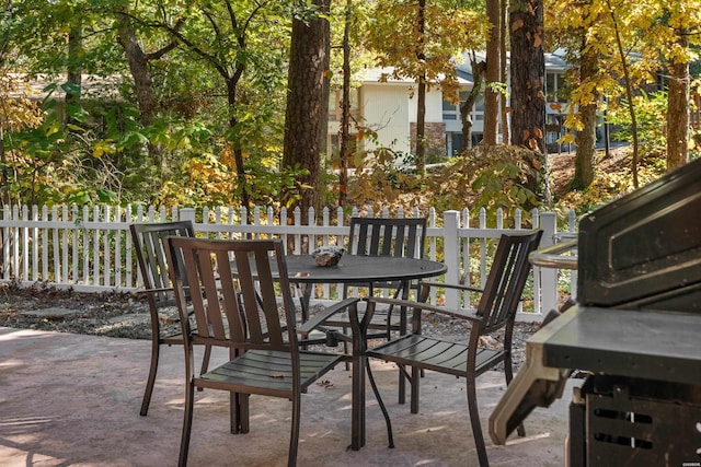 view of patio featuring fence and outdoor dining area