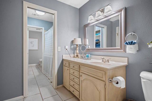 full bath featuring visible vents, toilet, vanity, tile patterned flooring, and baseboards