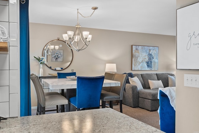 carpeted dining area featuring a notable chandelier