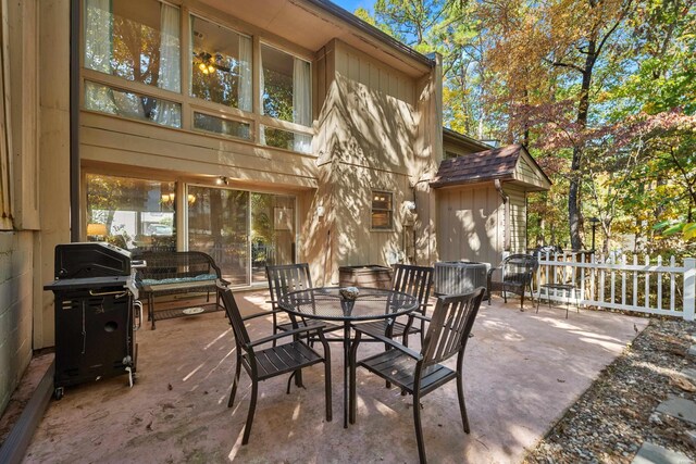 view of patio featuring outdoor dining area, fence, and grilling area