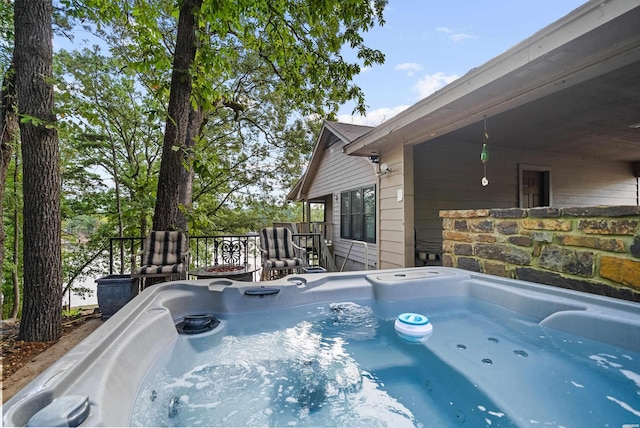 view of swimming pool featuring a hot tub