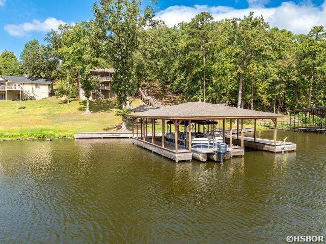 dock area with a water view and boat lift