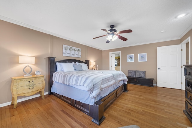 bedroom with ornamental molding, ceiling fan, baseboards, and wood finished floors