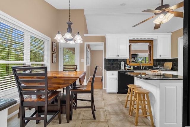 kitchen featuring black dishwasher, decorative light fixtures, decorative backsplash, white cabinetry, and a sink