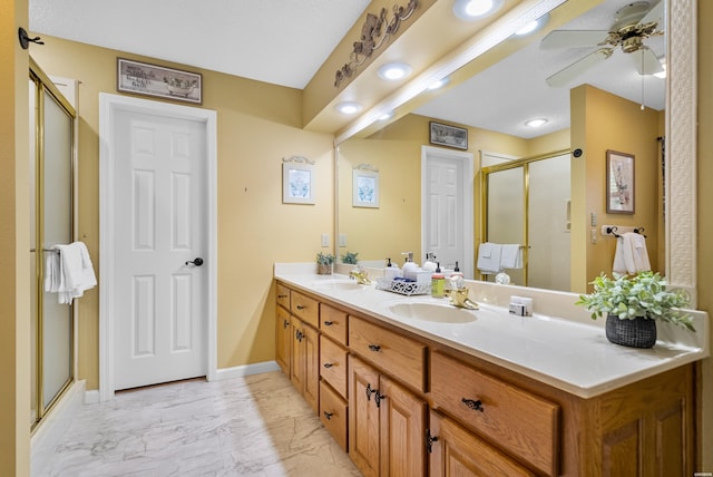 bathroom with marble finish floor, a sink, a shower stall, and double vanity