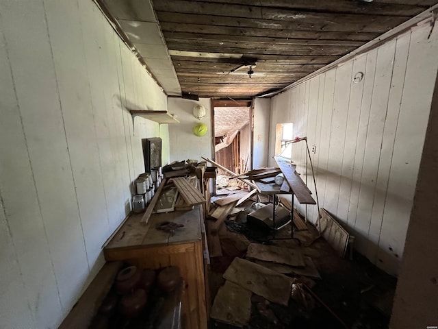 misc room featuring wood ceiling and wooden walls