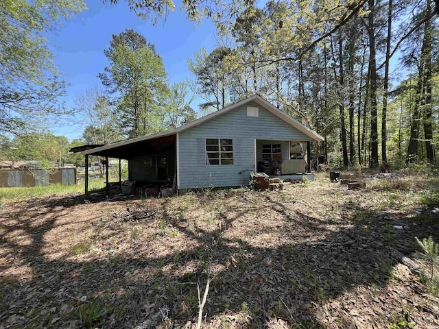 view of front of property with a porch and an attached carport