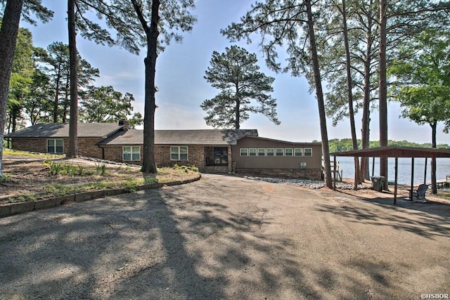 ranch-style house featuring a water view