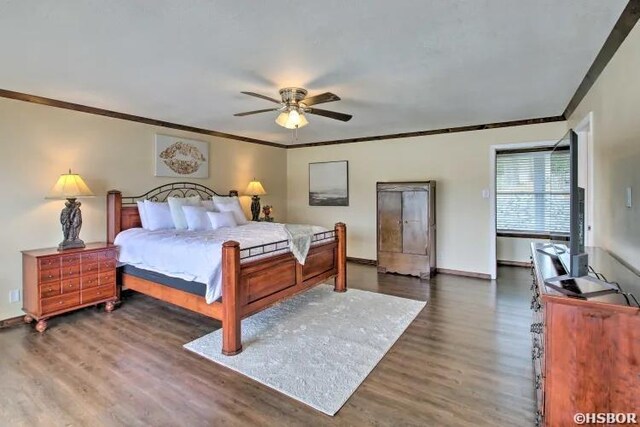 bedroom featuring a ceiling fan, crown molding, baseboards, and dark wood-type flooring