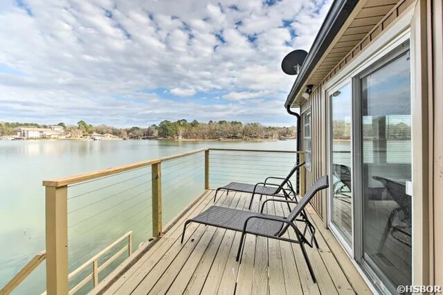 exterior space with a water view and a balcony