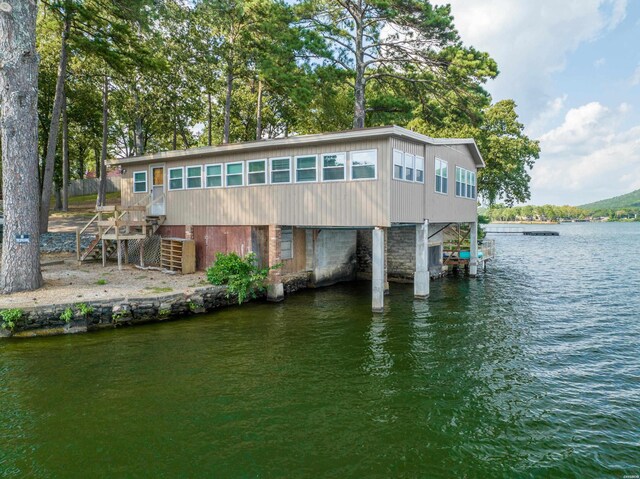 rear view of house with stairway and a water view