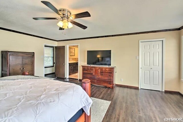 bedroom with baseboards, connected bathroom, ornamental molding, and dark wood-type flooring