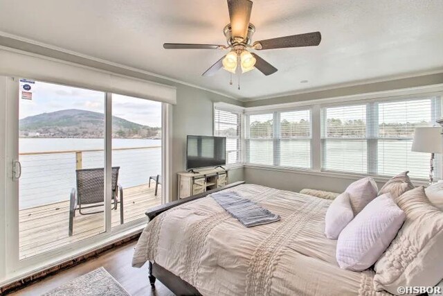 bedroom with ornamental molding, access to outside, a ceiling fan, and wood finished floors